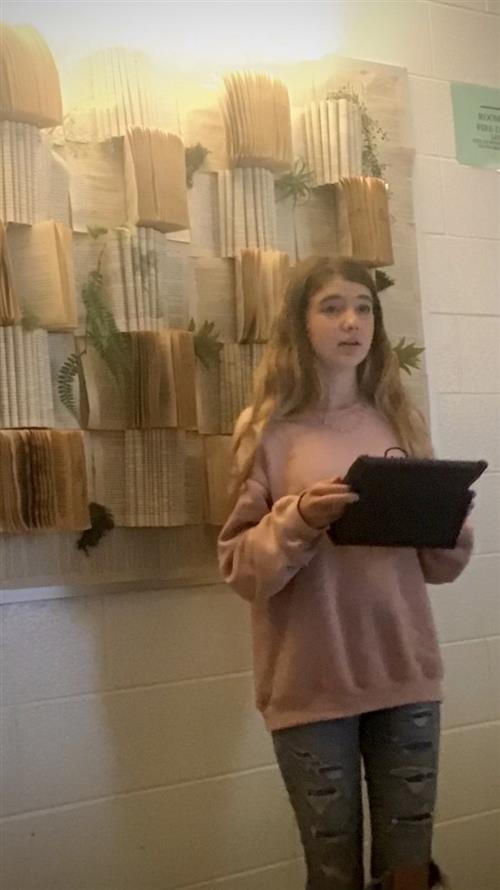 student reading their poetry to the class